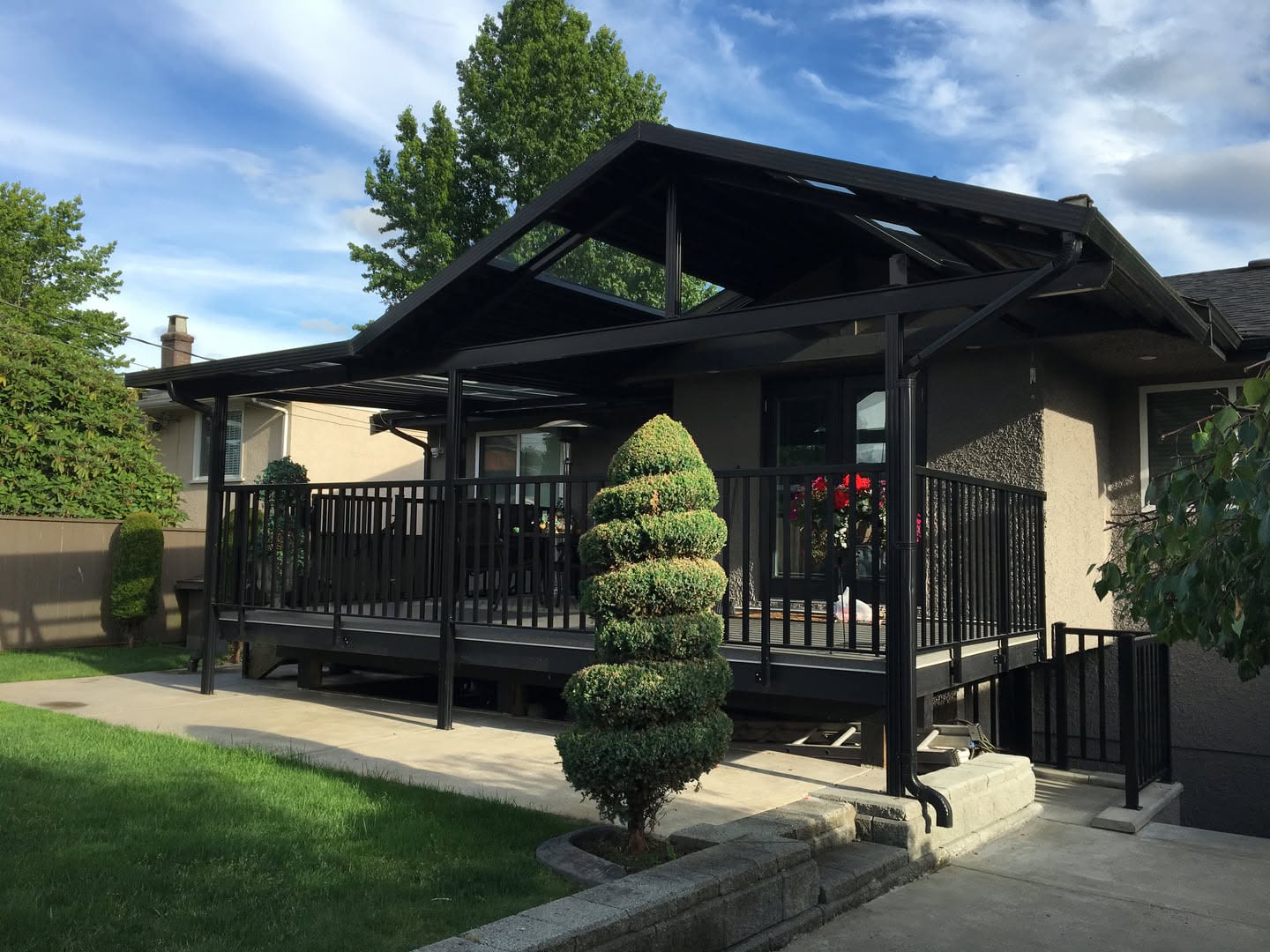 Covered deck with patio roof structure