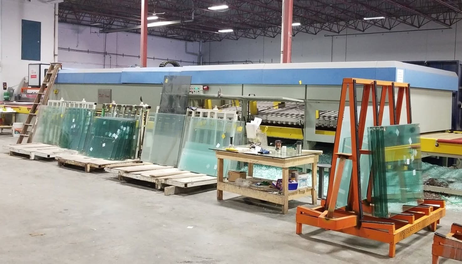 Glass panels on racks in a fabrication shop