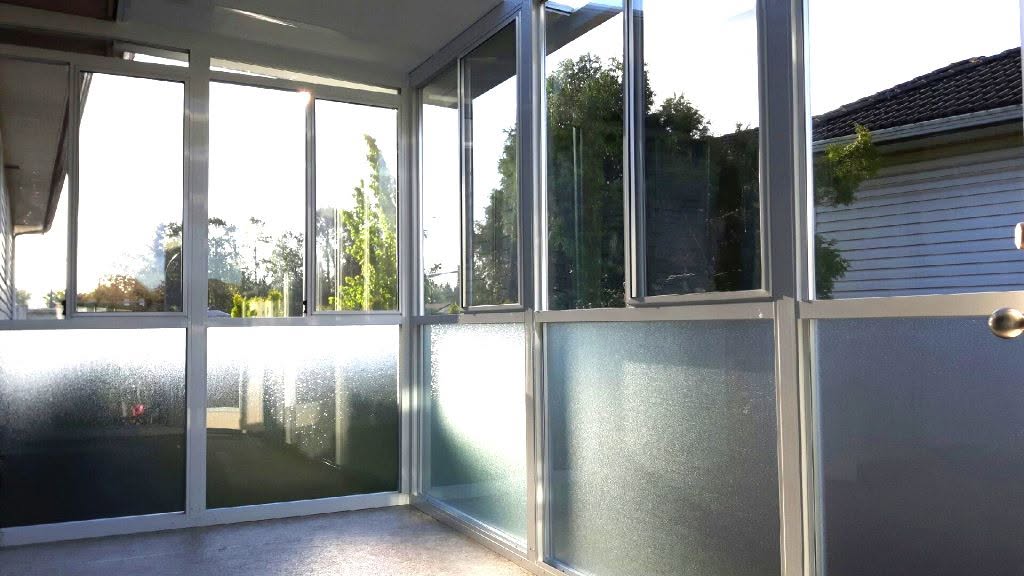 Aluminum framed glass enclosure with frosted lower panels