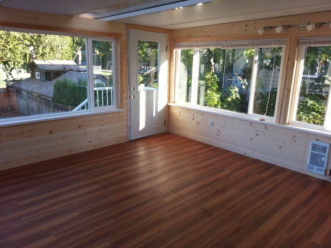 Sunroom interior with pine tongue and groove walls and wood floor